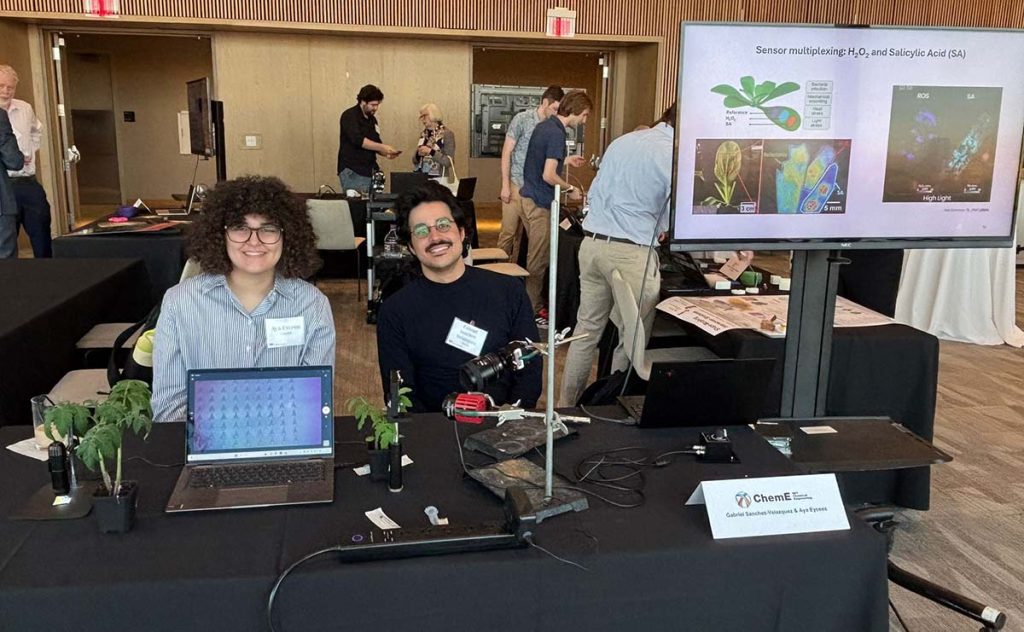 Graduate students Aya Eyceoz and Gabriel Sanchez Velazquez showcasing their sentinel plant 